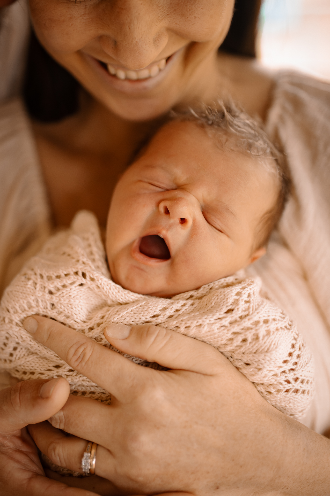 Yawning newborn baby captured by a Hawkes Bay newborn photographer during a calm in-home session.