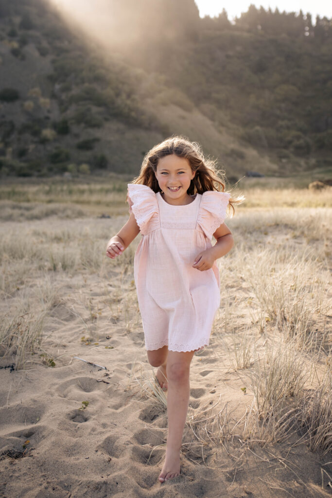 Girl running on Beach sunset photoshoot with Lightkeeper Photography in Hawkes Bay