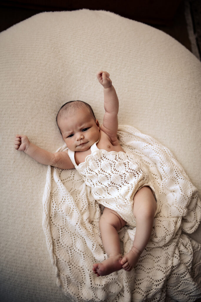 Newborn Baby stretching during in home natural newborn photoshoot in Hawkes Bay